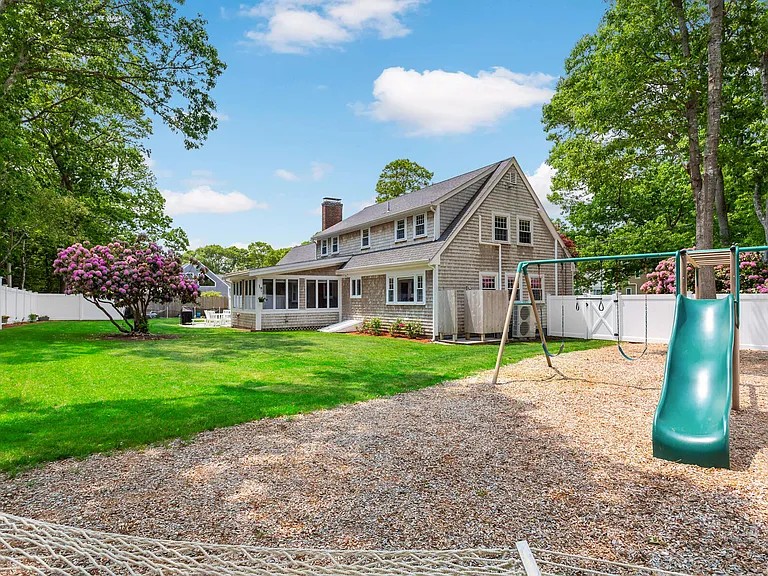 Backyard playground with swing set and slide