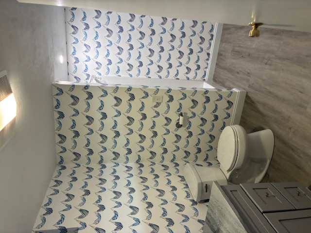 Basement bathroom with boat wallpaper